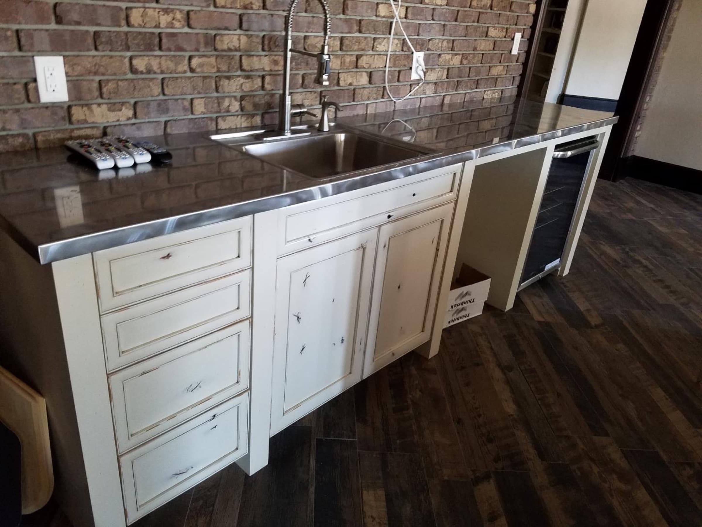 Curved bar with distressed white cabinetry