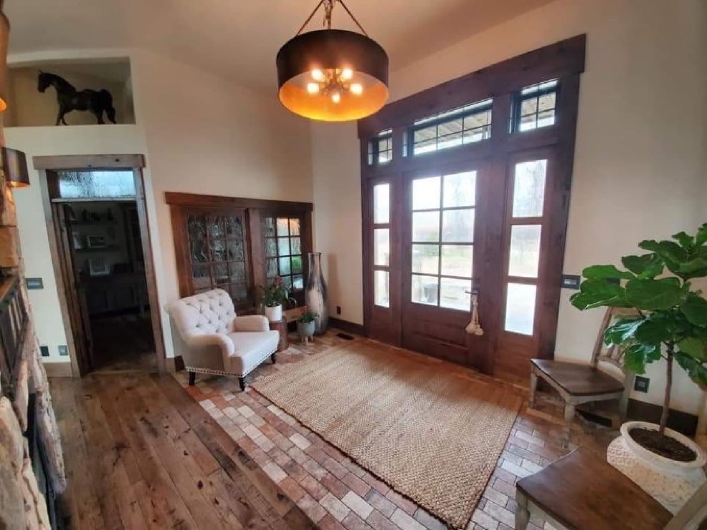 Entry foyer with a stained wood door surround, transoms, and French doors