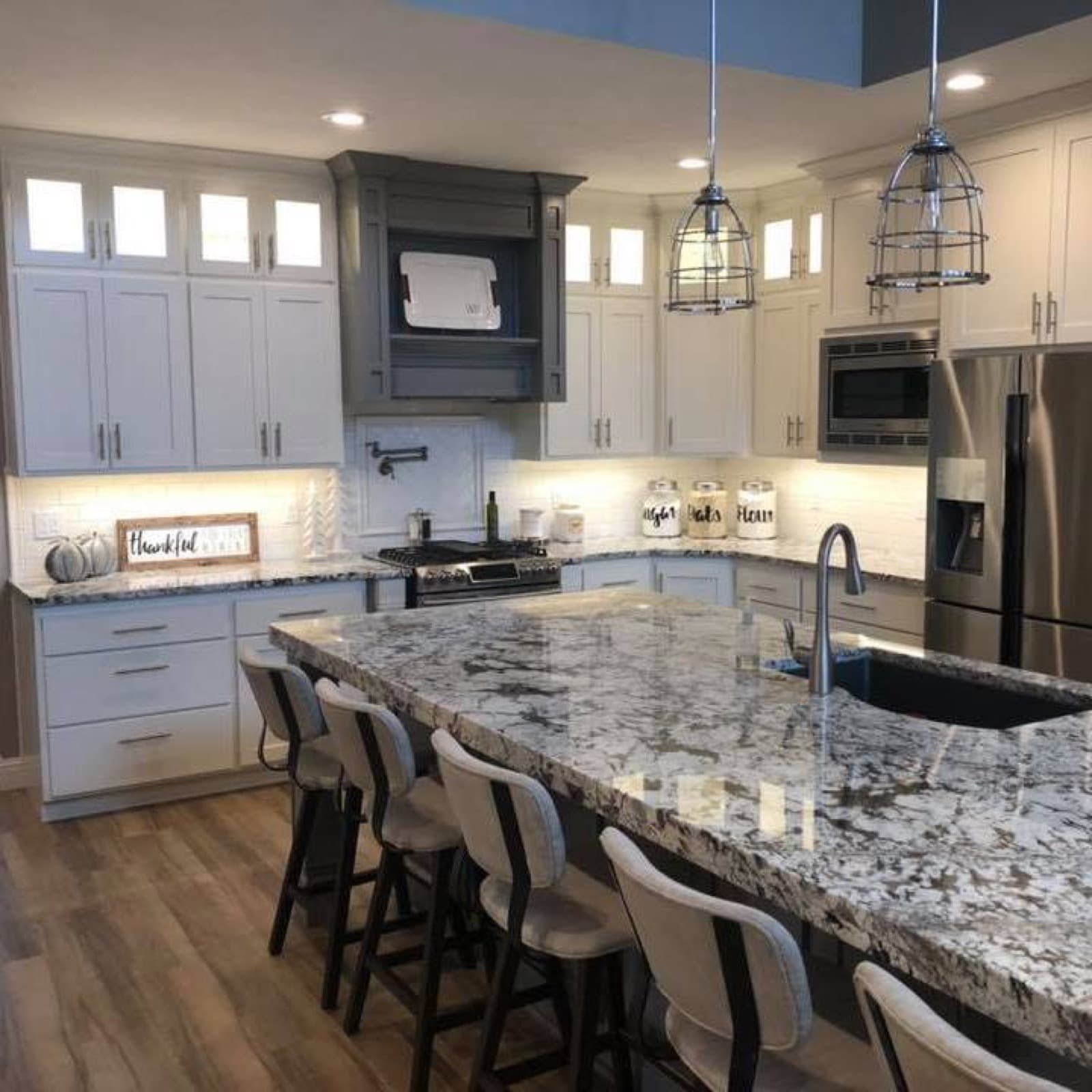 Custom kitchen with granite counters and pendant lighting