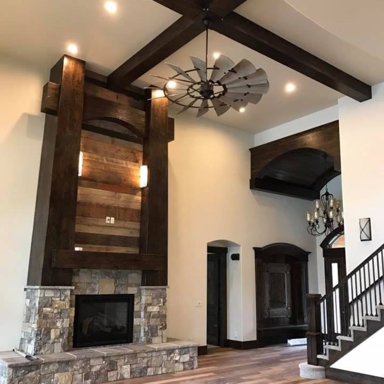 Living room with a stone fireplace and wood beams