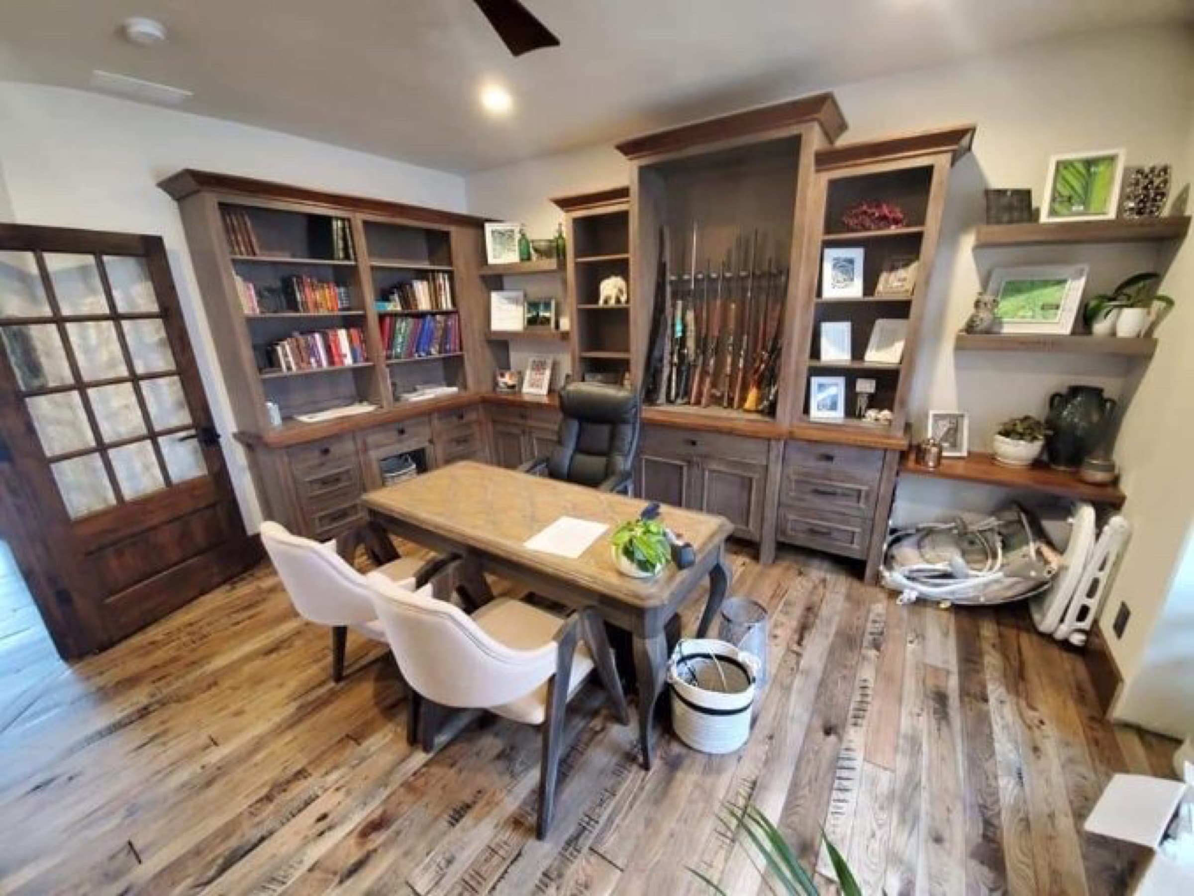 Office built-in bookcases with a center gun display