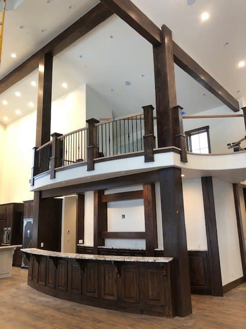 Curved staircase with a custom metal-and-wood railing