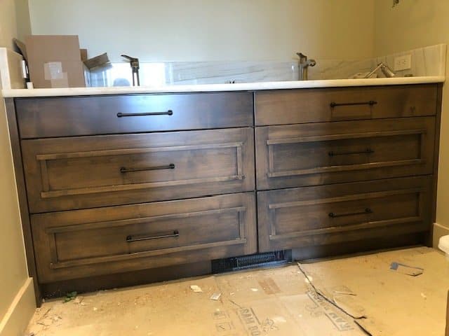 Long custom vanity run beneath a wall of windows