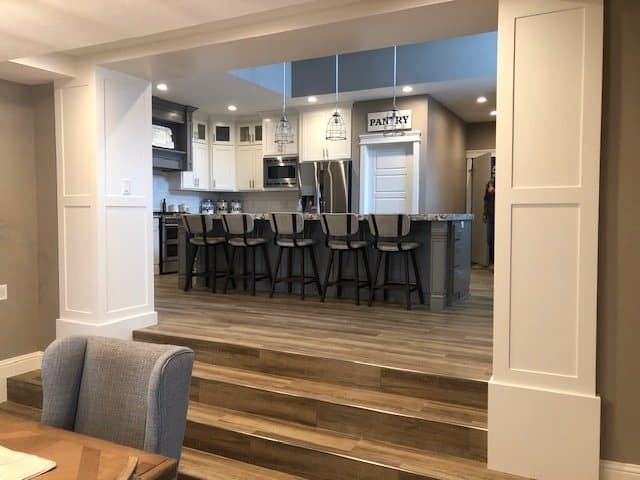 Custom kitchen island with seating and hardwood floors
