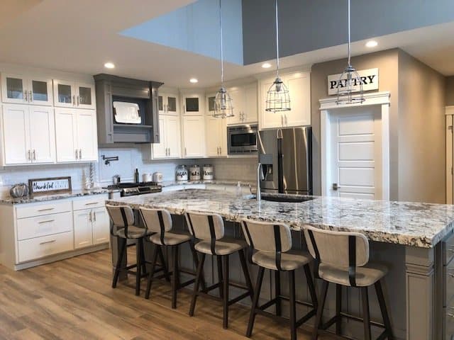 Bright white custom kitchen with a stone-top island
