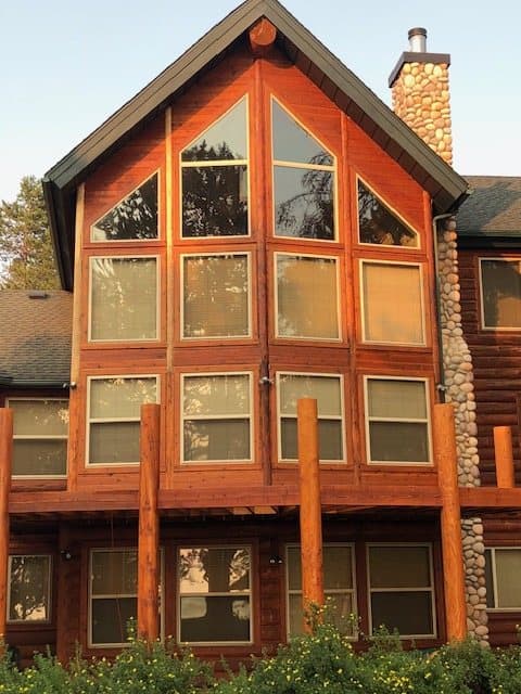 Log cabin with an arched window and new decking