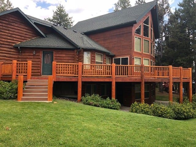 Log cabin with a newly built deck and railing