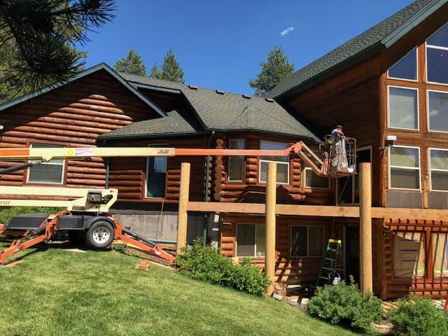 Log home with a rebuilt deck and railings