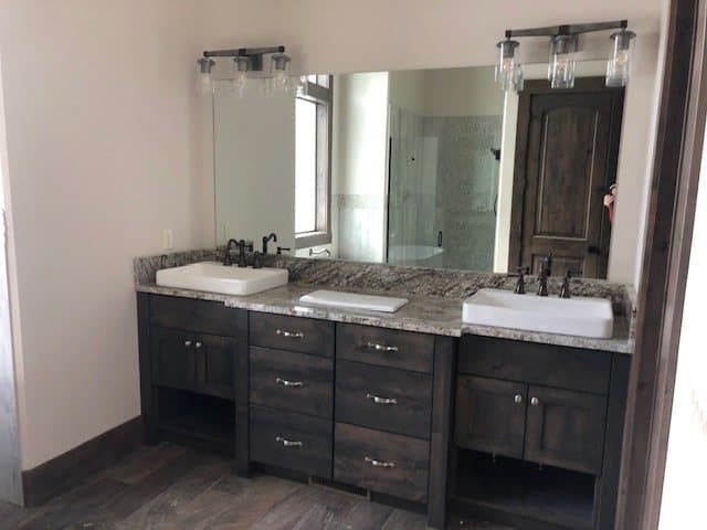 Salon vanities with framed mirrors and warm sconces