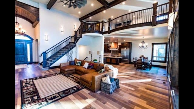 Vaulted great room with timber trusses and a stone fireplace