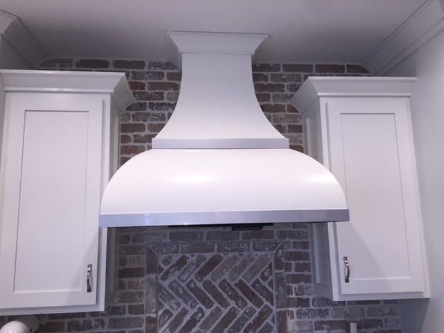 Elegant curved white range hood with tile inlay